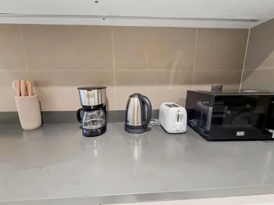 a kitchen counter with a coffee maker and a microwave at Stylish Deluxe Two Bedrooms In Dubai Marina in Dubai