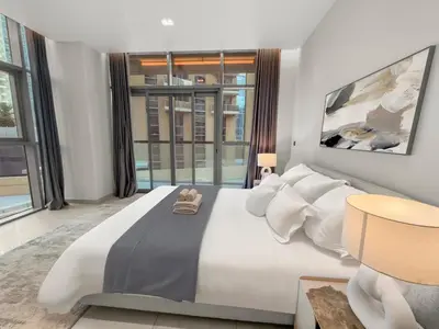 a bedroom with a large bed with a large window at Stylish Deluxe Two Bedrooms In Dubai Marina in Dubai