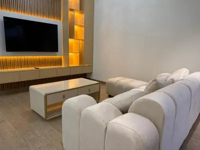 a living room with white couches and a tv at Heart of Marina with Free Parking, Pool and Gym in Dubai