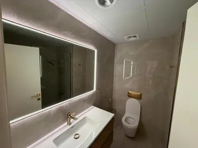 a bathroom with a sink and a mirror and a toilet at Heart of Marina with Free Parking, Pool and Gym in Dubai