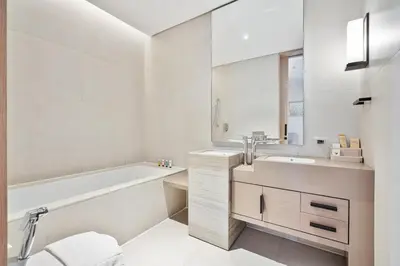 a white bathroom with a tub and a sink at Elegant 3 bed Haven in Address JBR Tower 1 in Dubai