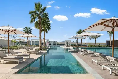 a swimming pool with lounge chairs and umbrellas at Elegant 3 bed Haven in Address JBR Tower 1 in Dubai