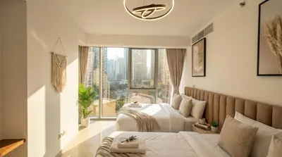 a bedroom with two beds and a large window at Trident Grand! Near Beach, Pool and Gym Access! In JBR-Dubai Marina in Dubai