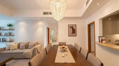a living room with a table and a couch at Trident Grand! Near Beach, Pool and Gym Access! In JBR-Dubai Marina in Dubai