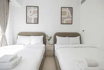 two beds sitting next to each other in a room at Trident Grand! Near Beach, Pool and Gym Access! In JBR-Dubai Marina in Dubai