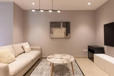a living room with a couch and a table at Spacious 3BR with Large Terrace in Dubai