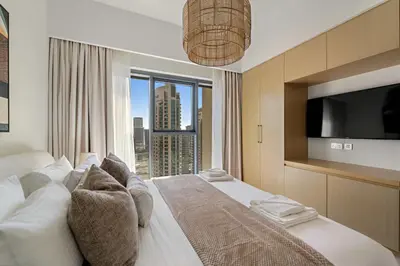 a bedroom with a large bed with a large window at Silkhaus Luxurious 1BR with Balcony Pool and Gym Downtown in Dubai