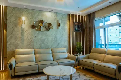 a living room with a couch and a table at 902, Royal Residencies, Dubai Sports City in Dubai