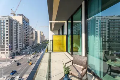 a balcony of a building with a view of a city at GuestReady - Cozy Stay | Near Parks | JVC in Dubai