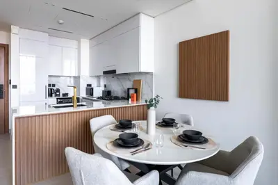 a dining room with a white table and chairs at GuestReady - Cozy Stay | Near Parks | JVC in Dubai