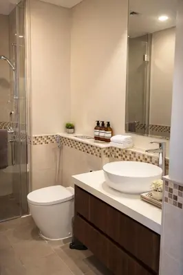 a bathroom with a sink and a toilet and a shower at Burj Khalifa View Stylish 1BR in Business Bay in Dubai