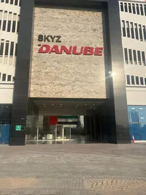 a building with a sign on the front of it at Skyz by Danube, Brand new Studios in Arjan in Dubai