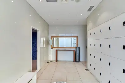 a hallway with white walls and a large window at 1BR 42nd Floor Palm Jumeriah & Sea View- 5 Sleeps in Dubai