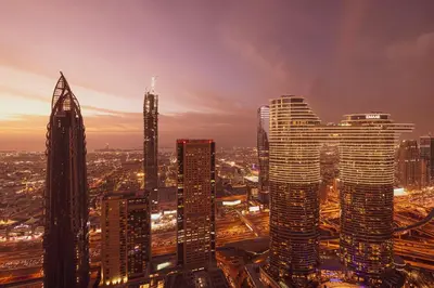 a city skyline at night with tall buildings at Burj Vista! Great High Floor View! Mall Connected! Amazing Pool, Gym and Location! in Dubai