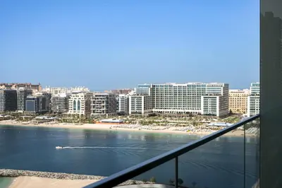 a view of a beach from a balcony at Beachfront 1BR with Private Beach Access Renovated in Dubai