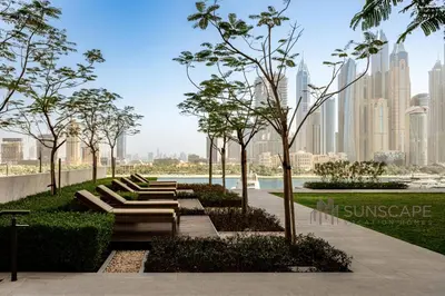 a park with benches and trees in front of a city at Beachfront 1BR with Private Beach Access Renovated in Dubai
