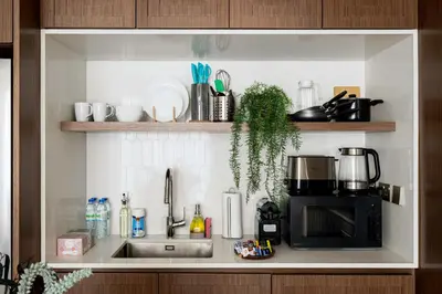 a kitchen counter with a sink and a microwave at Beachfront 1BR with Private Beach Access and Balcony in Dubai