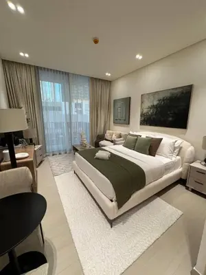a large bedroom with a large bed and a desk at Modern and Serene Studio - JVC in Dubai