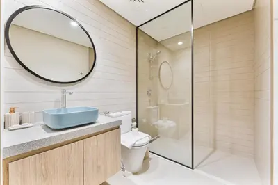 a bathroom with a sink and a toilet and a mirror at Modern 2Bed with Iconic Burj Khalifa & Canal Views in Dubai