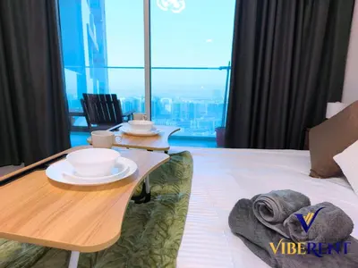 a room with a table with cups and plates on it at Skyz by Danube Studio Dubai in Dubai