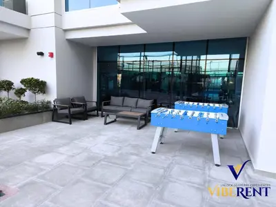 a blue bench sitting in front of a building at Skyz by Danube Studio Dubai in Dubai