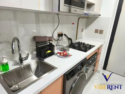 a small kitchen with a sink and a microwave at Skyz by Danube Studio Dubai in Dubai
