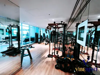 a gym with treadmills and machines in a room at Skyz by Danube Studio Dubai in Dubai