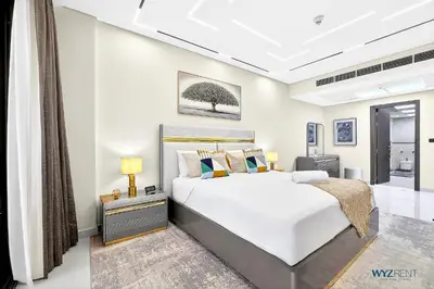 a bedroom with a large white bed and a window at Enchanted 1BR Royal Amwaj Burj View & Private Beach in Dubai