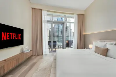 a hotel room with a bed and a tv at Westminster Imperial Avenue Downtown in Dubai