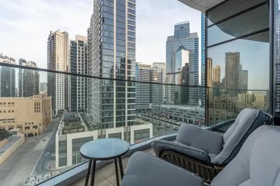 a balcony with chairs and a view of a city at Westminster Imperial Avenue Downtown in Dubai
