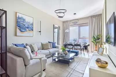 a living room with a couch and a table at Frank Porter - Sparkle Tower 1 in Dubai