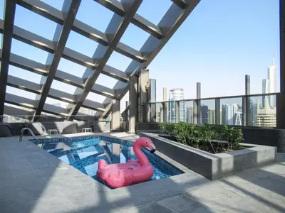 a pink flamingo float in a pool on a building at Frank Porter - Sparkle Tower 1 in Dubai