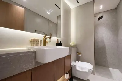 a bathroom with a sink and a toilet at Refined Luxury 1BR Binghatti Azure in Dubai
