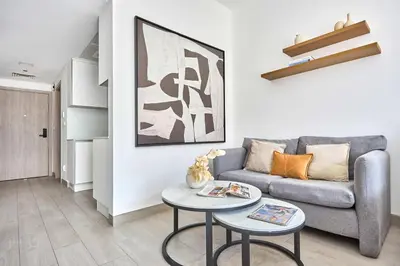 a living room with a couch and a table at Frank Porter - Luma 21 in Dubai