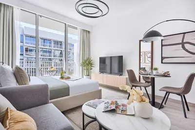 a hotel room with a king sized bed and a tv at Frank Porter - Luma 21 in Dubai