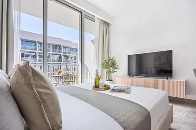 a hotel room with a bed and a large window at Frank Porter - Luma 21 in Dubai