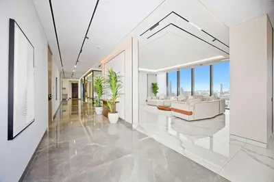 a living room with white furniture and large windows at Stylish 4BR Penthouse with Maids Room & Modern Amenities in Dubai