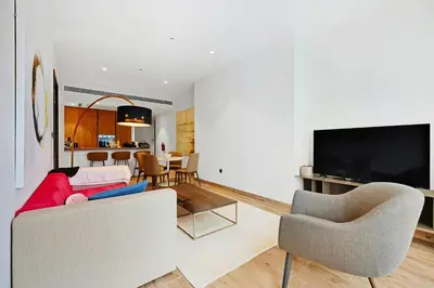 a living room with a couch and a tv at Elegant 1-Bed Apartment with Premium Comforts in Dubai