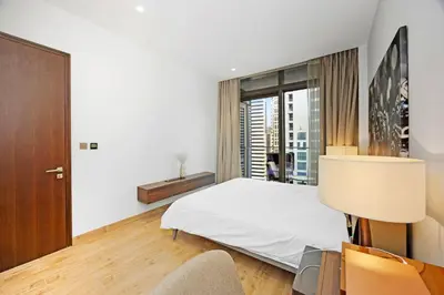 a bedroom with a white bed and a window at Elegant 1-Bed Apartment with Premium Comforts in Dubai
