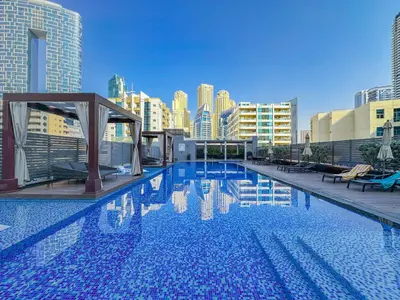 a large swimming pool on the roof of a building at StudioOne Tower Sky-High Marina Chic, Sea Views & Designer Pool in Dubai
