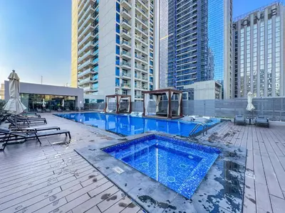 a swimming pool on top of a building with tall buildings at StudioOne Tower Sky-High Marina Chic, Sea Views & Designer Pool in Dubai