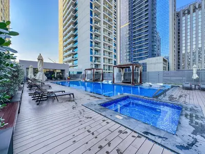 a swimming pool on top of a building with tall buildings at StudioOne Tower Sky-High Marina Chic, Sea Views & Designer Pool in Dubai