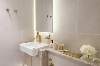 a white bathroom with a sink and a mirror at Chic 1BR Urban Retreat Binghatti Phantom in Dubai