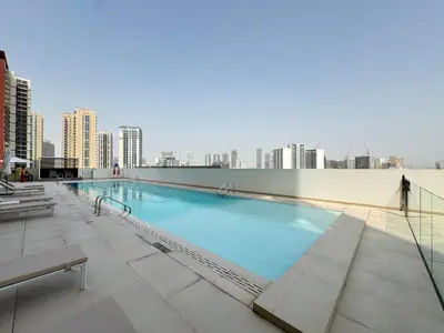 a large swimming pool on the roof of a building at Elegant 2BR Apartment with Private Pool in JVC in Dubai