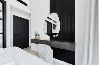 a bedroom with a bed and a tv on a wall at Elegant 2BR Apartment with Private Pool in JVC in Dubai