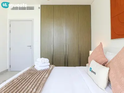 a bedroom with a bed with towels on it at HiGuests - Beautiful Sea Facing 1BR at Emaar Beachfront in Dubai