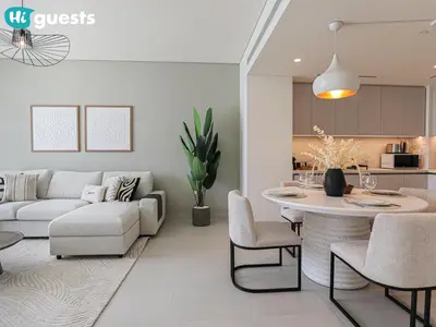 a living room with a couch and a table at HiGuests - Beautiful Sea Facing 1BR at Emaar Beachfront in Dubai