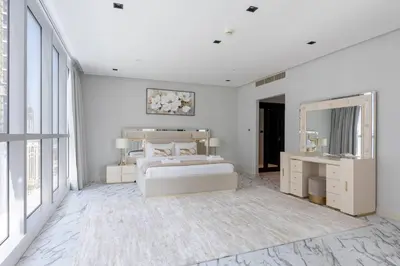 a white bedroom with a large bed and a mirror at Penthouse Vibes 3BR Billiard & Air Hockey in Dubai