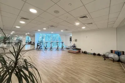 a large room with a person sitting in a gym at Penthouse Vibes 3BR Billiard & Air Hockey in Dubai