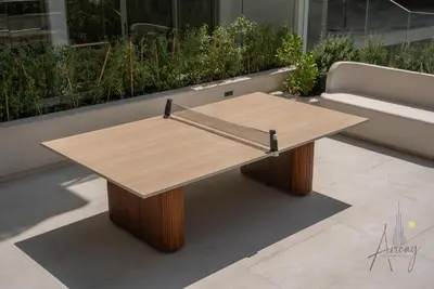 a wooden coffee table on a patio with a couch at Sweet Escape 1BR in JVC Near Circle Mall in Dubai